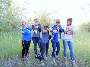 Group of girls with slingshots and paintballs